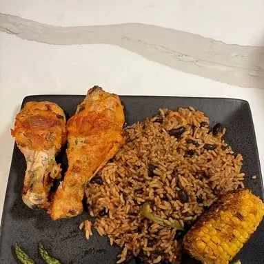 Roasted chicken drumsticks with rice and beans, grilled corn and asparagus.
